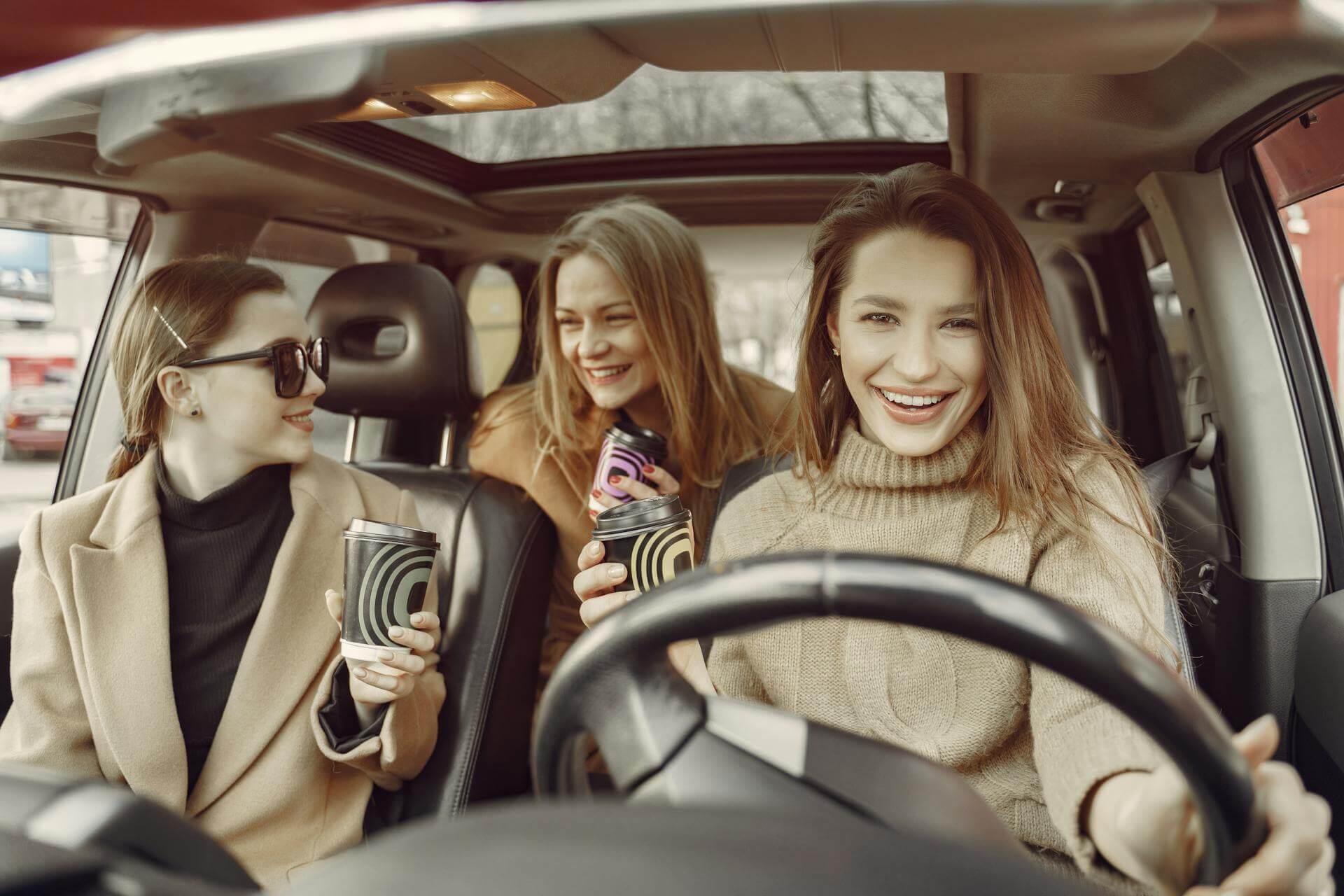 Happy girls driving a car